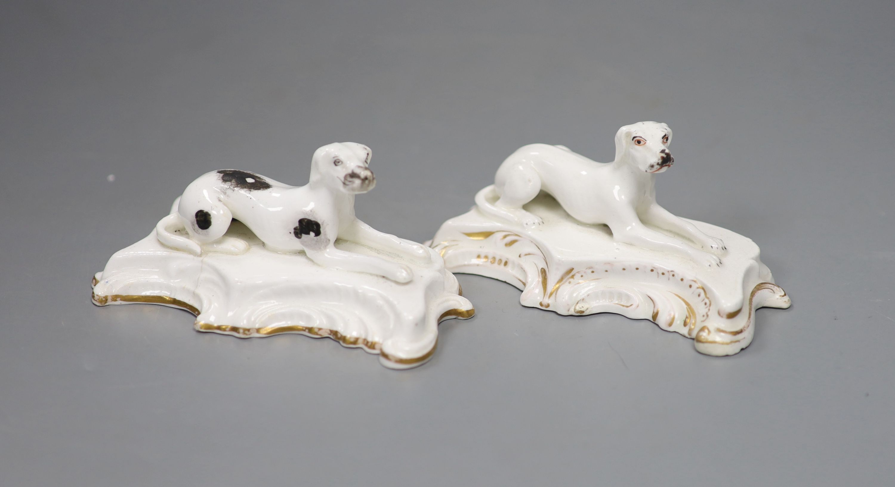 Two similar Staffordshire porcelain models of recumbent setters, c.1830-50, 12cm long